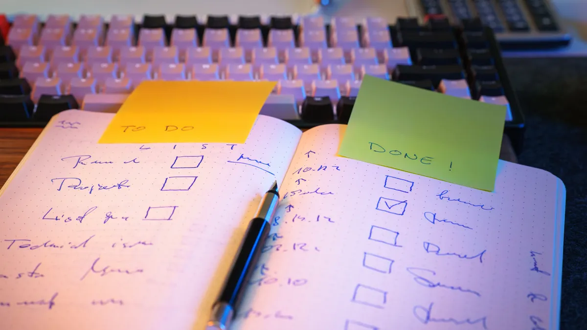 open notebook with checkboxes and sticky notes